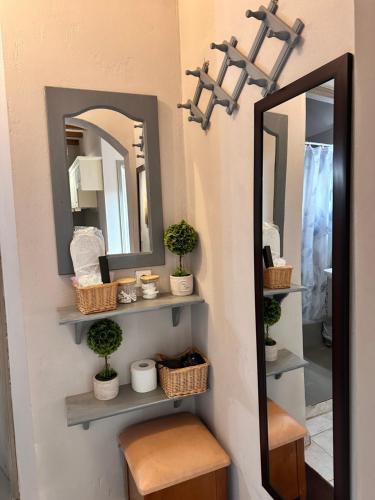 a bathroom with mirrors and a stool and a mirror at Pandoras House Arachova in Arachova