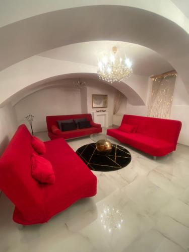a living room with red couches and a chandelier at Vienna Luxury Dream Home in Vienna