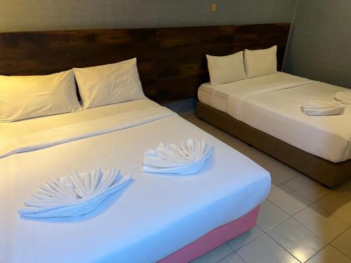 two beds in a hotel room with blue lights at HOTEL SRI SUTRA (BANDAR SUNWAY) in Petaling Jaya