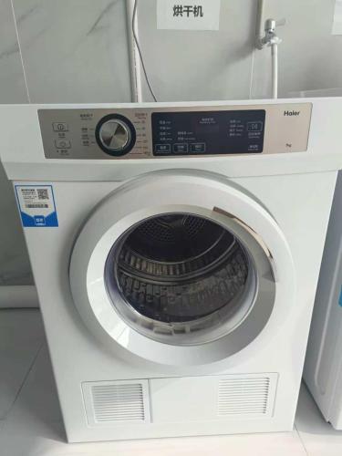 a white washing machine in a room at Kelly Jinyue Hotel in Chengdu