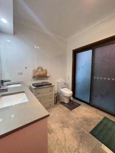 a bathroom with a sink and a toilet in it at Garden Retreat House Sunnybank Hills - Super quite and Peace in Brisbane