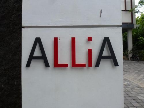 a sign for aala on a white building at Allia Residence in Nusa Dua
