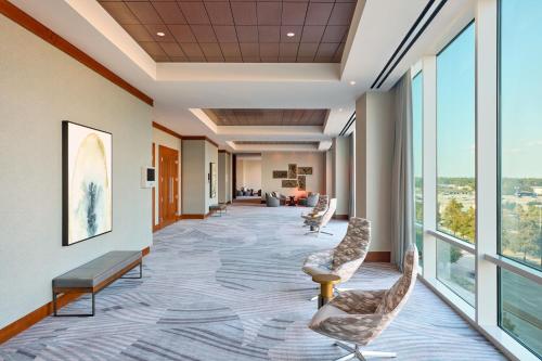 a hallway in a hospital with chairs and windows at The Westin Houston, Memorial City in Houston