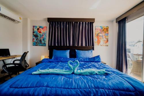 a bedroom with a blue bed with an octopus on it at Abunawas Merry Inn at Walking Street in Pattaya South
