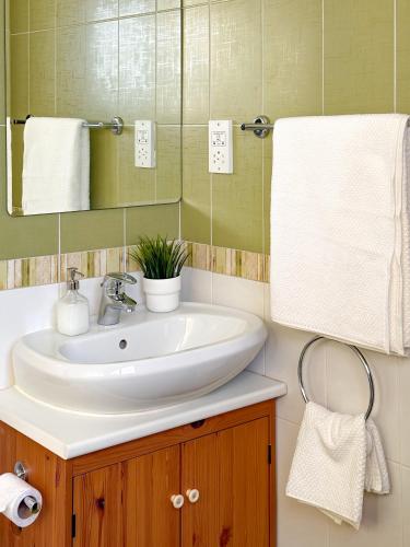 a bathroom with a sink and a mirror at Beachfront Villa with Private Pool and Exotic Fruit Garden in Pyla