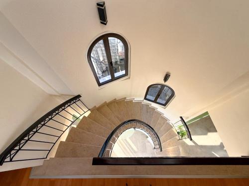 a spiral staircase in a building with two windows at Beachfront Villa with Private Pool and Exotic Fruit Garden in Pyla