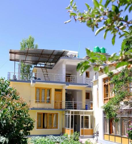 a large yellow building with a lot of windows at Hotel DE Suzain-Leh in Leh