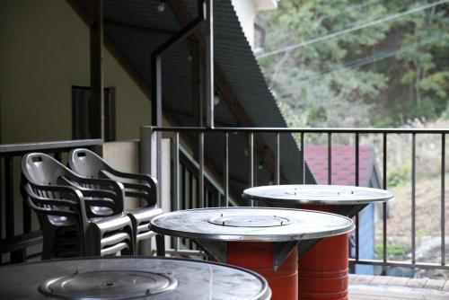 two tables and two chairs on a balcony at Samcheok Donghae Pension in Yeongdeok