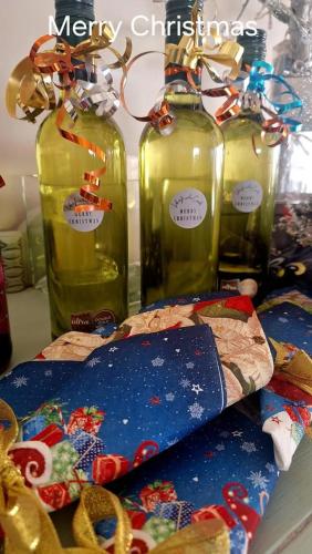 three glass bottles with christmas ornaments and a snowboard at Jeffreys Bay - Life on the Canals in Jeffreys Bay