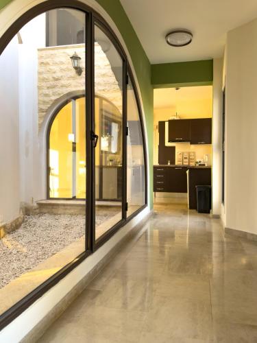 an open hallway with glass doors and a kitchen at Beachfront Villa with Private Pool and Exotic Fruit Garden in Pyla