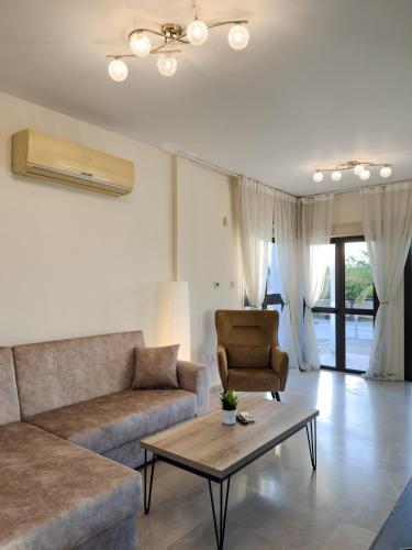 a living room with a couch and a coffee table at Beachfront Villa with Private Pool and Exotic Fruit Garden in Pyla