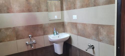 a bathroom with a sink and a toilet at Meghdoot river resort in Cochin