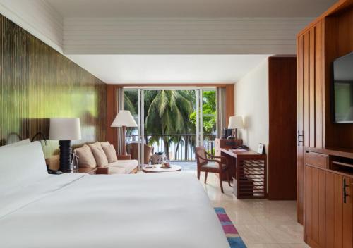 a bedroom with a bed and a living room at Mandarin Oriental, Sanya in Sanya