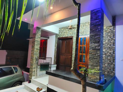 a house with a car parked in front of it at Sole shell Chalets in Kappil