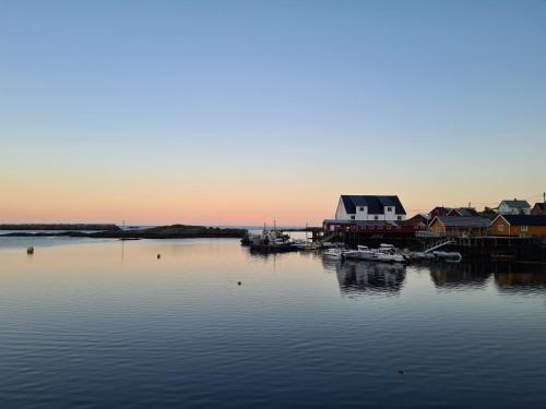 a large body of water with houses and boats at Explorers Cabin Lofoten Edge in Sørvågen