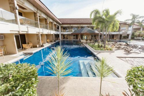 a swimming pool in front of a building with a resort at Cebu Westown Lagoon - South Wing in Cebu City