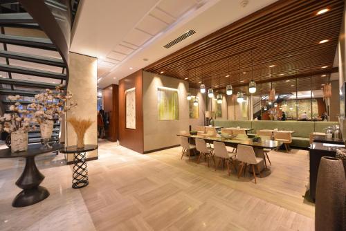 a dining room with a long table and chairs at Waxwing Hotel in Hatay