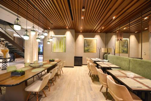 a dining room with long tables and chairs at Waxwing Hotel in Hatay