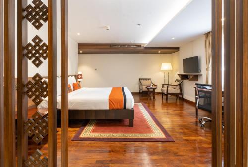 a hotel room with a bed and a desk at Ramada by Wyndham Kathmandu Dhumbarahi in Kathmandu