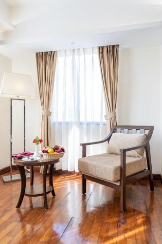a living room with a bench and a table at Ramada by Wyndham Kathmandu Dhumbarahi in Kathmandu