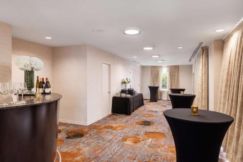 a hotel lobby with a bar with wine bottles at DoubleTree Suites by Hilton Austin Downtown Capitol in Austin
