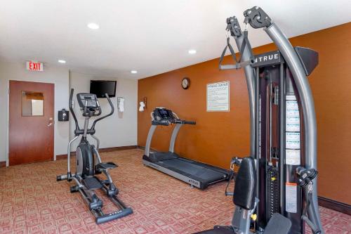 a gym with two treadmills and two exercise bikes at Quality Inn Raleigh Downtown in Raleigh