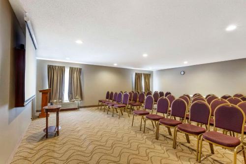 a room with rows of chairs and a podium at Quality Inn Raleigh Downtown in Raleigh