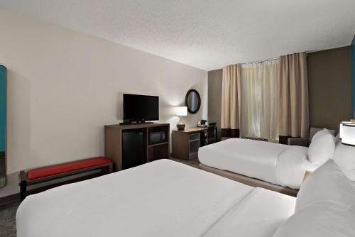 a hotel room with two beds and a flat screen tv at Comfort Inn & Suites Santee I-95 in Santee