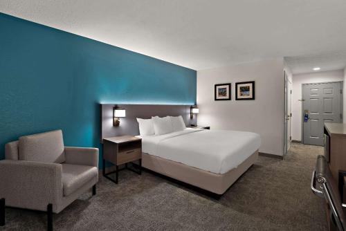 a hotel room with a bed and a chair at Comfort Inn & Suites Santee I-95 in Santee