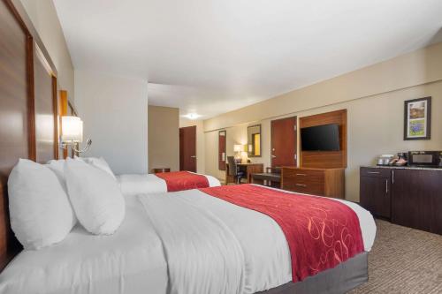 a hotel room with two beds and a television at Comfort Suites Old Town Spring in Spring