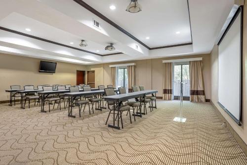 a conference room with tables and chairs and a screen at Comfort Suites Old Town Spring in Spring