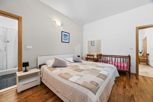 a bedroom with a large bed and a staircase at Villa Lavinija in Kavran