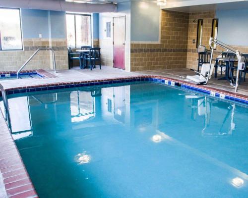 a swimming pool with blue water in a building at Sleep Inn & Suites Virginia Horse Center in Lexington