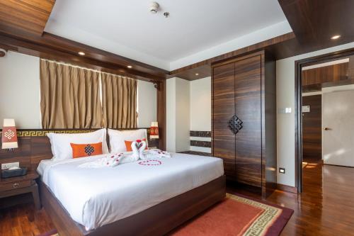 a bedroom with a large white bed in a room at Ramada by Wyndham Kathmandu Dhumbarahi in Kathmandu