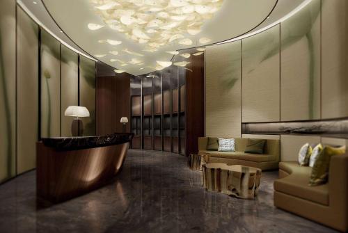 a lobby with a couch and a table in a building at Wyndham Grand Foshan Gaoming in Gaoming