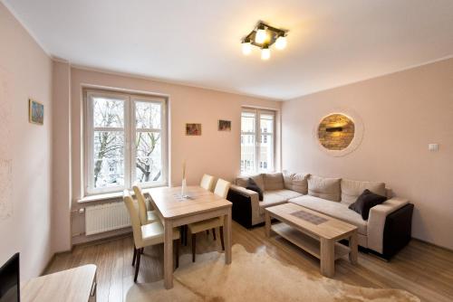 sala de estar con sofá y mesa en Gdańskie Apartamenty - Apartament Szeroka, en Gdansk