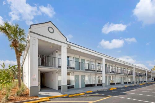 an exterior view of a building with a parking lot at Rodeway Inn in Orange Park