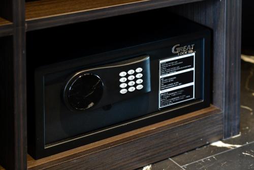 a microwave oven sitting inside of a wooden cabinet at Victora Hostel in Bangkok