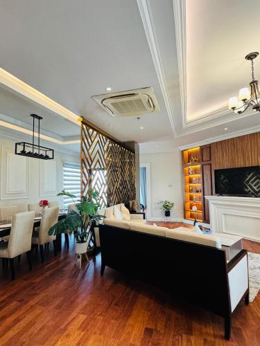 a living room with a couch and a dining room at Mintra Hotel in Vientiane