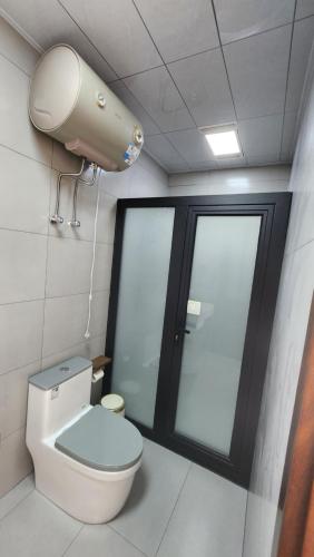 a bathroom with a toilet and a security camera at 古北御尚精品民宿Gubeiyushang in Gubeikou