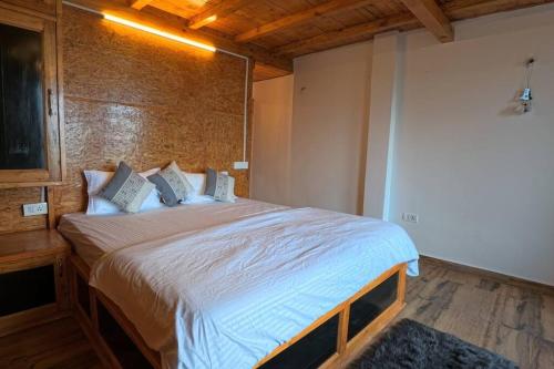 a bedroom with a large bed in a room at Cabin by The Woods - Mukteshwar - Nature - Romantic - Secluded in Mukteswar