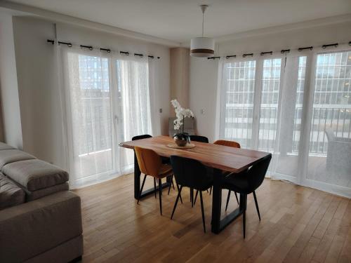 - une table à manger et des chaises dans le salon dans l'établissement Grand appartement familial paris13, à Paris
