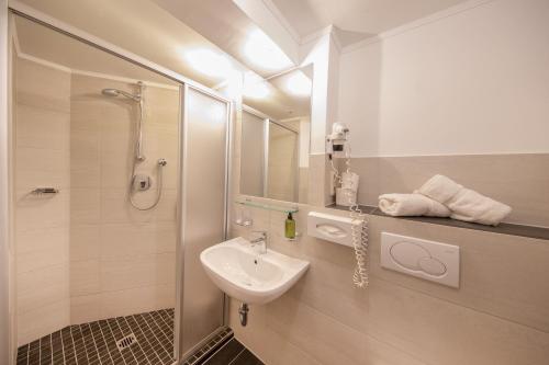 a bathroom with a sink and a shower at Hotel Garni Schönblick in Sölden