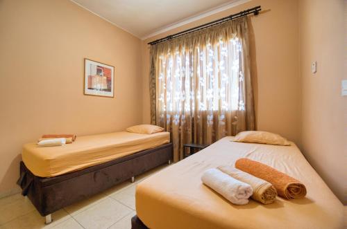 two beds in a room with a window at Diana 41 Beautiful Private Room in Apt in Paphos City