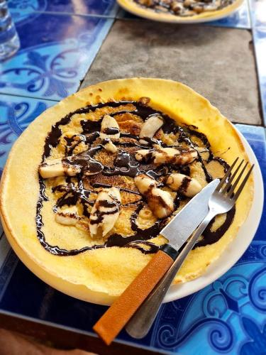 a dessert on a plate with a fork and knife at Mama Pap - Tad Lo in Ban Donkhagnoung