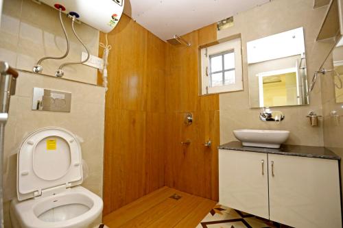 a bathroom with a toilet and a sink at Nuh Serenity - 2 BHK Luxury Apartment in Srinagar in Srinagar