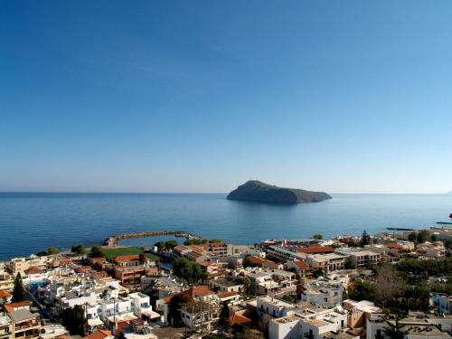 an aerial view of a city and the ocean at Cretan Blu Platanias in Plataniás