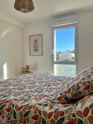 une chambre avec un grand lit et une fenêtre dans l'établissement Narb'home, Cosy , Parking, Balcon, à Narbonne