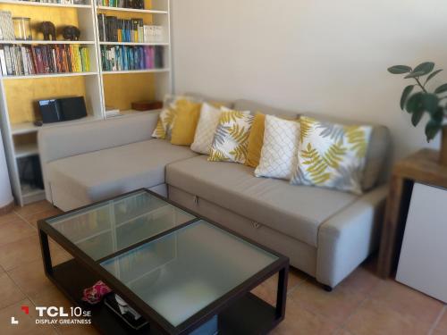 a living room with a couch and a coffee table at Playa Oliva con vista al mar y con piscina in Oliva