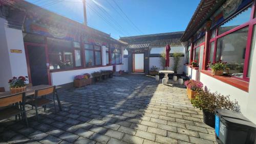 a courtyard of a building with benches and plants at 古北御尚精品民宿Gubeiyushang in Gubeikou
